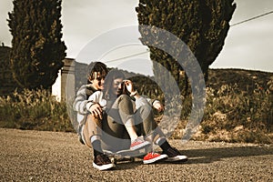 Young couple riding skateboarding having fun. Modern skateboarders millennials