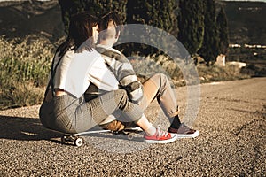Young couple riding skateboarding having fun. Modern skateboarders millennials