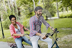 Young couple riding on the tandem bicycle