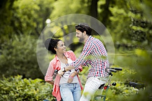 Young couple riding on the tandem bicycle