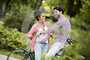 Young couple riding on the tandem bicycle