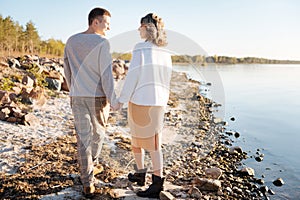 Young couple romanticly walking near the river