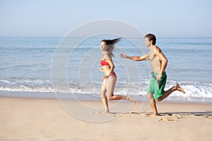 Young couple running on beach