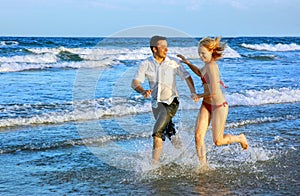 Young couple running at the beach