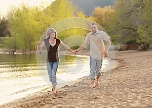 Young couple running on beach together