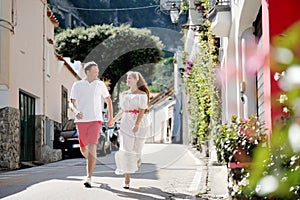 Young couple running and looking each other, Positano, Italy