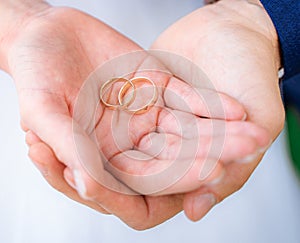 Young couple's hands with engagement rings