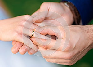 Young couple's hands with engagement rings