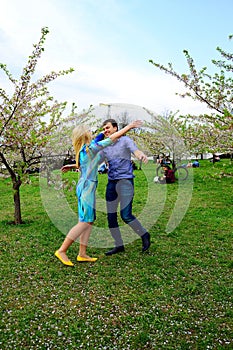 Young couple in the sakura's garden in park