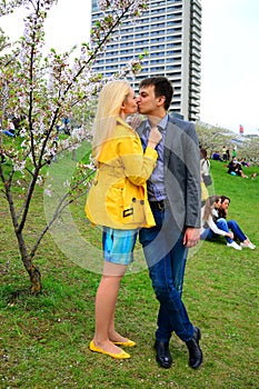 Young couple in the sakura's garden in park