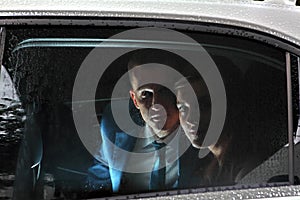 Young couple in salon car, newlyweds look out the window