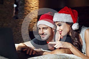 Young couple searching for christmas gift online