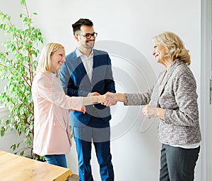 young couple shaking hands deal contract real estate investment business agreement agent handshake signing