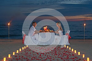 Young couple share a romantic dinner with candles