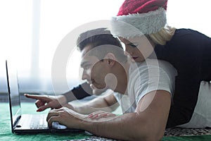 Young couple shopping online for Christmas