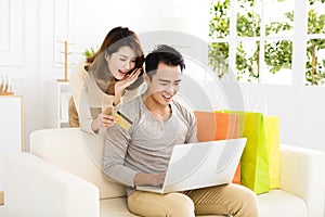 Young couple shopping online with credit card