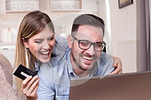 Young couple shopping online at home