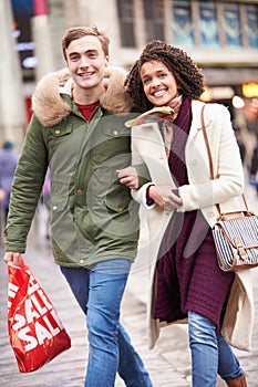 Young Couple Shopping Outdoors Together