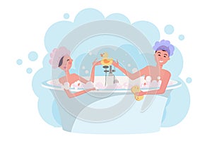 Young couple in shower caps taking a bath. Girl and guy are having fun in bubble bath. Elegant bathtub with yellow rubber duck.