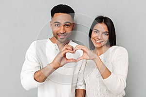 Young couple showing heart with hands