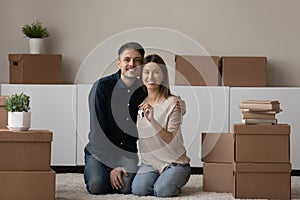 Young couple showing keys feel happy on moving day