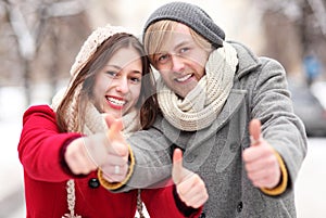 Young couple showing thumbs up