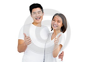 Young couple showing thumbs up