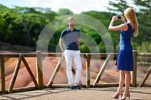 Young couple sightseeing Chamarel coloured earths