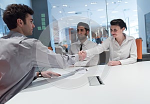 Young couple signing contract documents on partners back