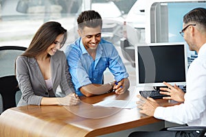 Young Couple Signs a Contract For the Purchase of a New Car