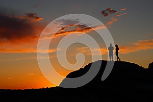 Young couple silhouette with colorful sky