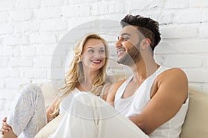 Young Couple Sit On Pillows Floor, Happy Smile Hispanic Man And Woman Lovers In Bedroom