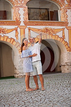 Young couple siteseeing on a hot summer afternoon on a paved street photo