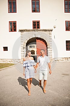 Young couple siteseeing on a hot summer afternoon on a paved street