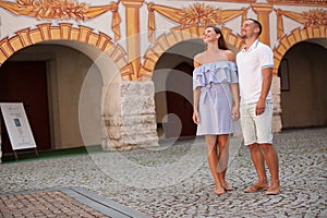 Young couple siteseeing on a hot summer afternoon on a paved street