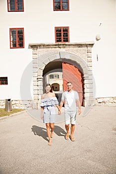 Young couple siteseeing on a hot summer afternoon on a paved street