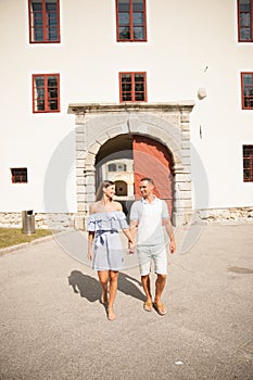 Young couple siteseeing on a hot summer afternoon on a paved street photo