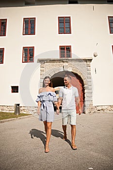 Young couple siteseeing on a hot summer afternoon on a paved street photo