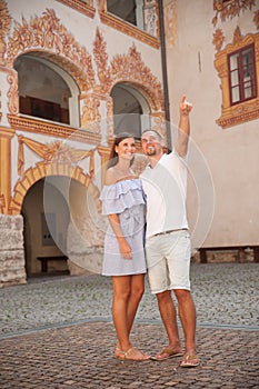 Young couple siteseeing on a hot summer afternoon on a paved street photo