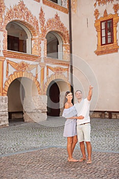 Young couple siteseeing on a hot summer afternoon on a paved street photo