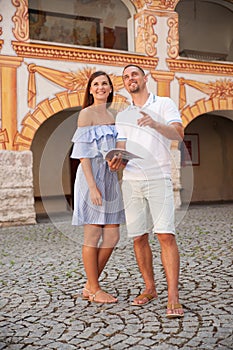 Young couple siteseeing on a hot summer afternoon on a paved street photo