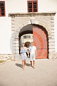 Young couple siteseeing on a hot summer afternoon on a paved street photo