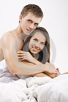 Young couple sitting in bed