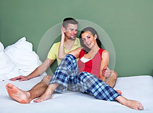 Young couple sitting in a bed