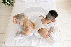 Young Couple Sitting In Bed, Having Conflict Relationships Problem, Sad Negative Emotions Hispanic Man And Woman