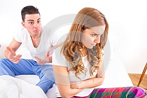 Young couple sitting on the bed because of Relationship Difficulties.