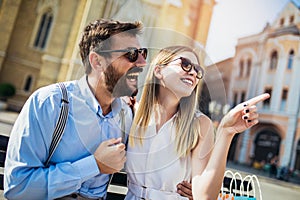 Young couple sitting on a bench hugging and having fun