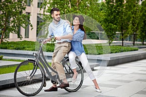 Young couple sitting on a bicycle