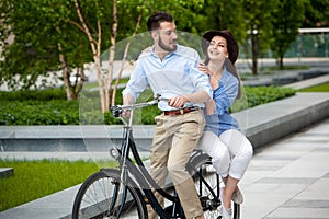 Young couple sitting on a bicycle