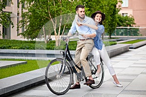 Young couple sitting on a bicycle